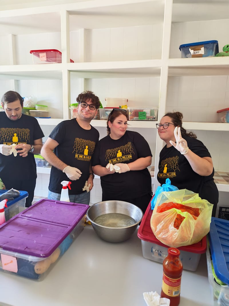 Young single adults from the Palermo Italy Stake sort and organize food and supplies at Casa Scalabrini 634 in Rome, Italy.