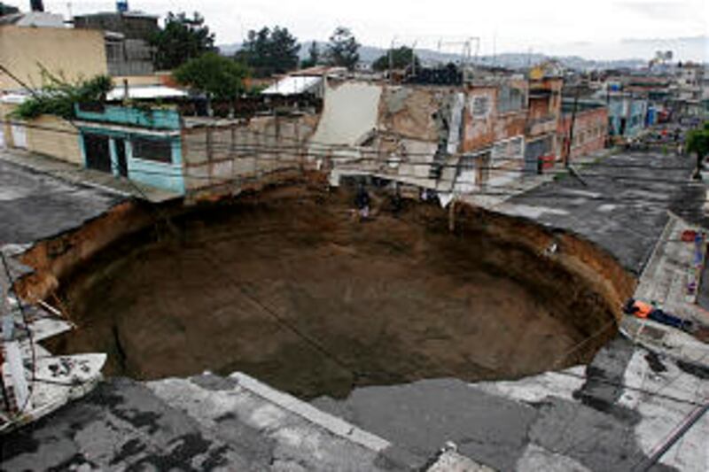 A massive sinkhole covering a street intersection in downtown Guatemala City is an indication of the