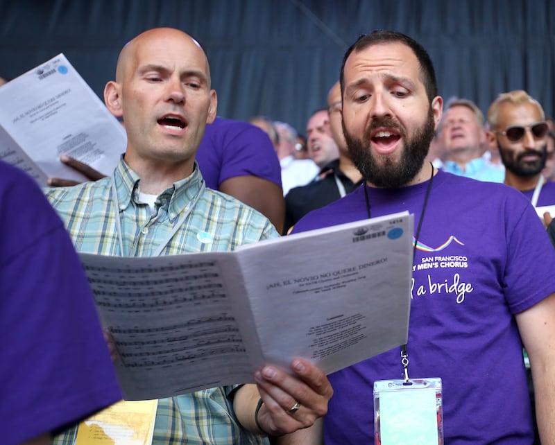 David Andrade, right, a member of the San Francisco Gay Men’s Chorus, sings with the Mormon Tabernacle Choir during soundcheck at the Shoreline Amphitheatre in Mountain View, Calif., on Monday, June 25, 2018.