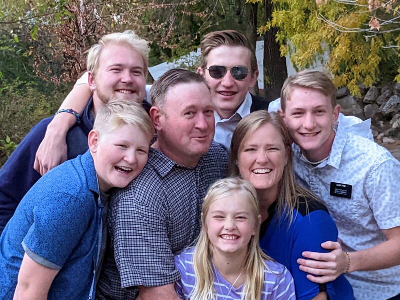 Preston Page, in the sunglasses, smiles for a photo with his family.