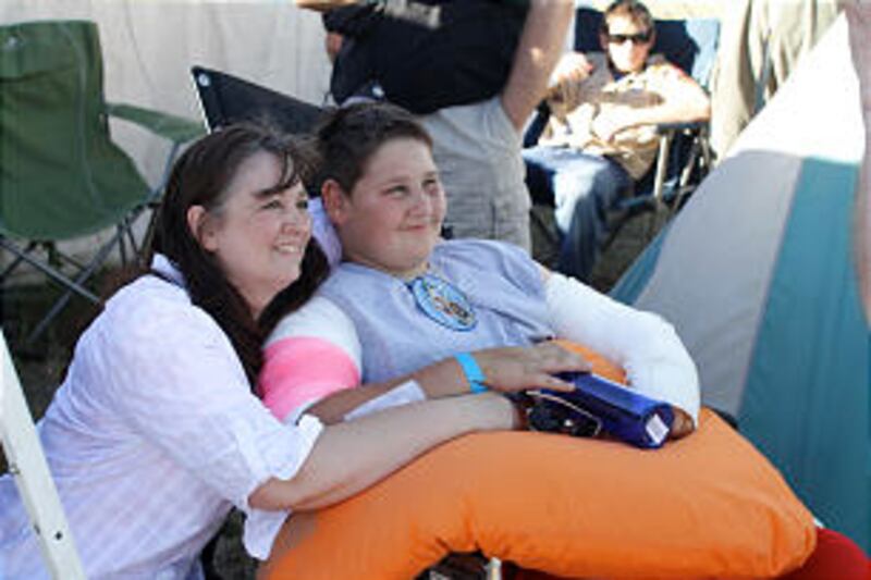 Jacob Hymas, 12, and his mother, Ann Hymas, share a moment together June 27 at the 2013 Rise Up Scou
