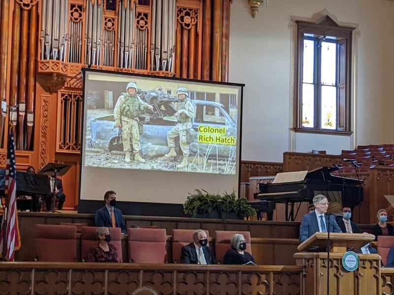 Kenneth L. Alford, a BYU professor of Church history and doctrine, speaks during the Tuesday, Feb. 15, 2022, Ensign College devotional in the Assembly Hall on Temple Square in Salt Lake City. On the screen is a photo of Col. Richard Hatch.