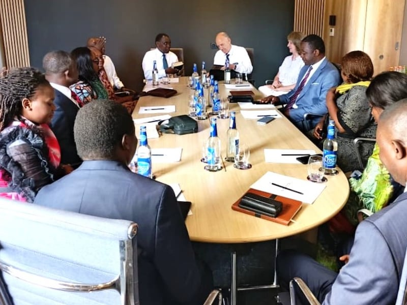 Elder Edward Dube and Elder Paul B. Pieper lead a focus group discussion around a table in Lubumbashi, Democratic Republic of the Congo, April 30, 2026.