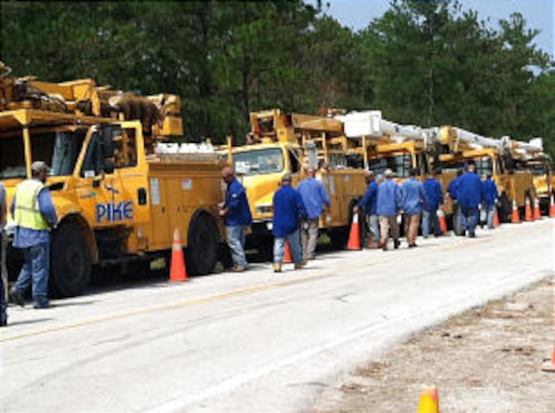 Employees of Pike Electric Corp. in North Carolina go to work after Hurricane Irene hit August 27.