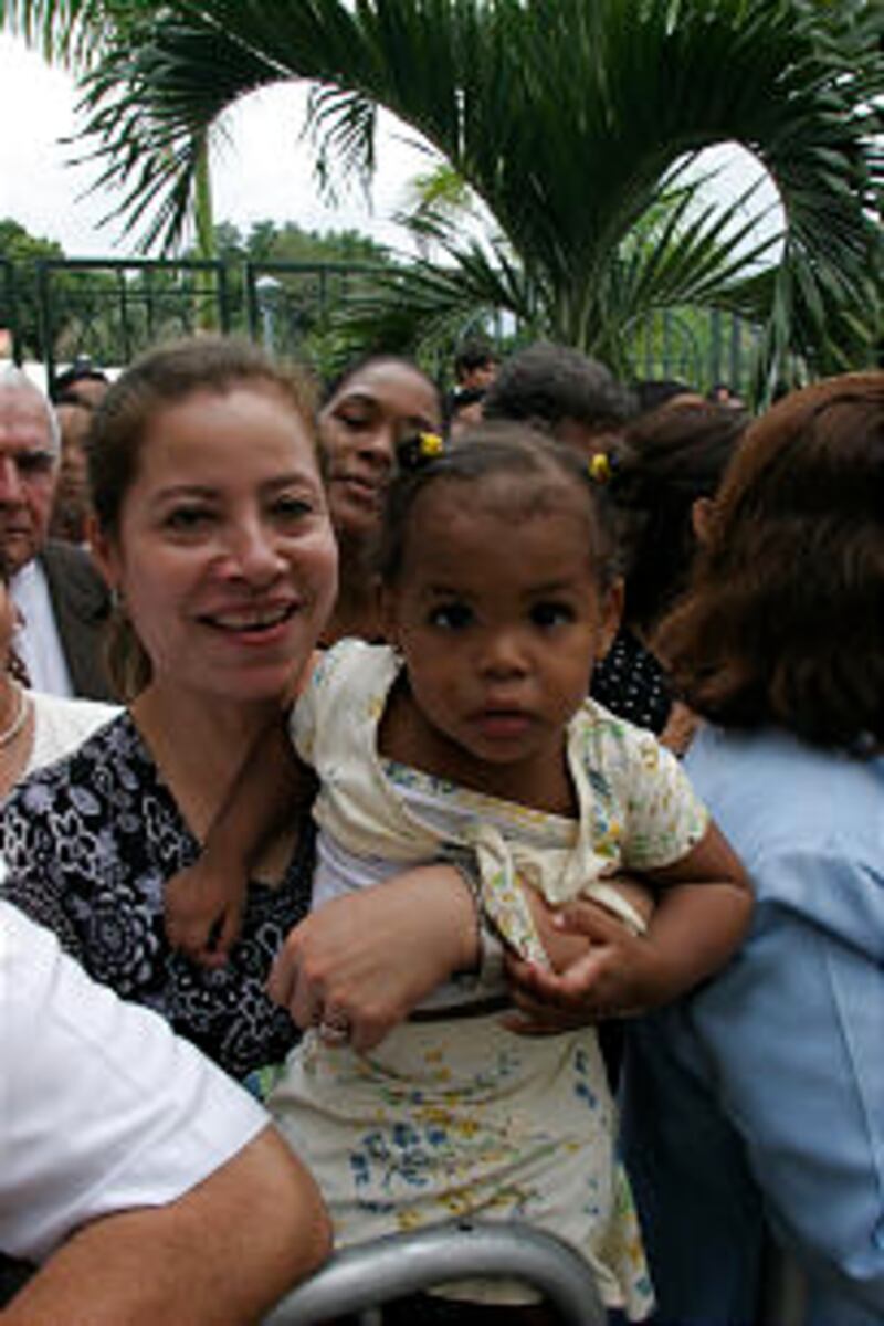 Mother and her young daughter attend the cornerstone ceremony during the dedication of the Panama Ci