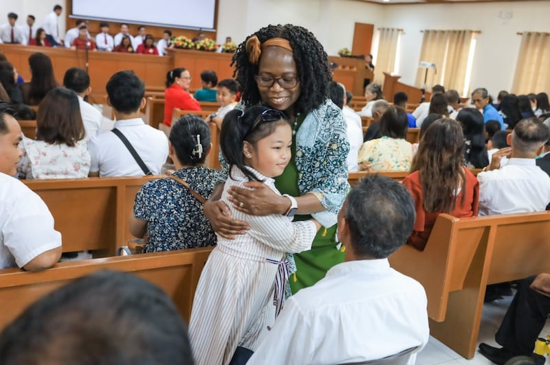 President Rosemary K. Chibota hugs a child in Tacloban City, Philippines, Sept. 19, 2026.