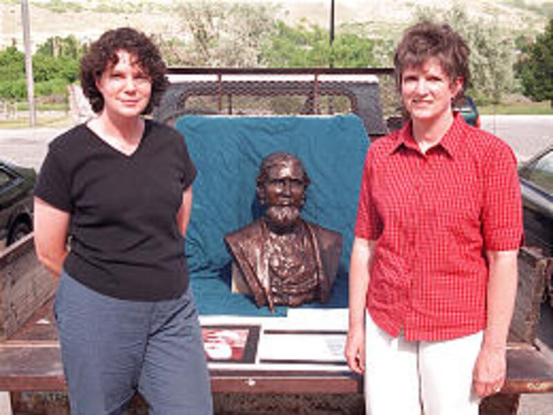 Brenda Hansen, left, and Trudy Iverson display their sculpture of ancestor John Erik Forsgren.