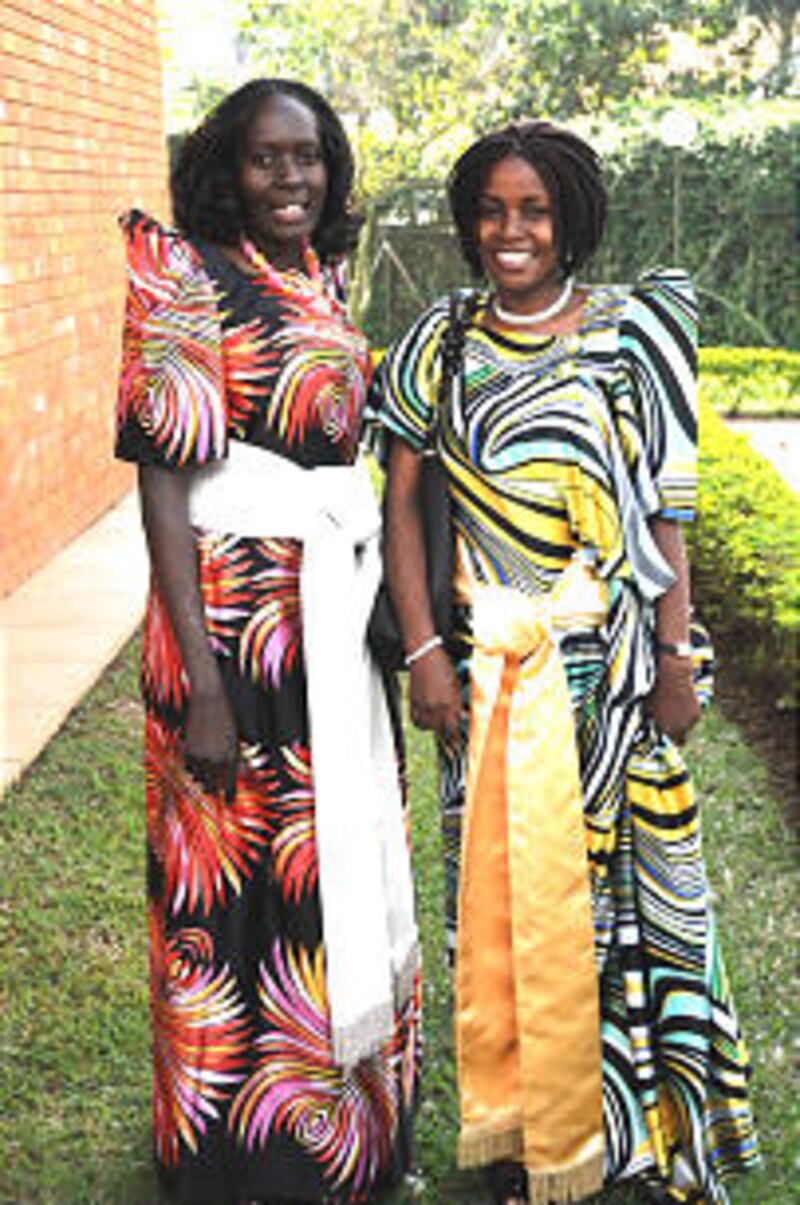 Two sisters smile outside the meeting house.