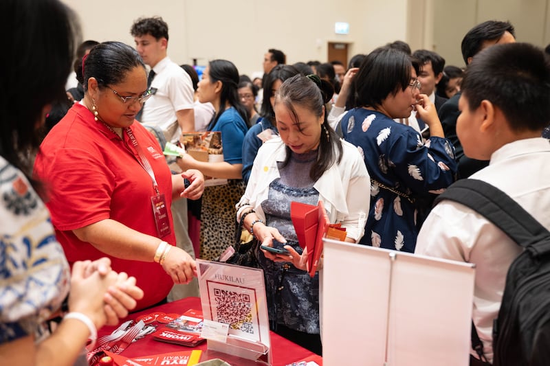 Participants visit the BYU–Hawaii booth at the Asia Area education fair in Bangkok, Thailand, Oct. 19, 2025.