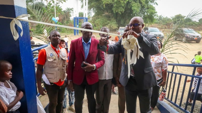 Elder Alfred Kyungu cuts the ribbon to complete the handover of an elementary school in Lower Margibi County, Liberia, Feb. 21 2026.