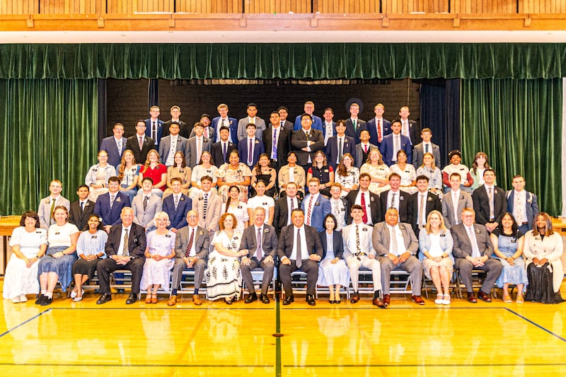 Missionaries in the California Oakland/San Francisco Mission take a large group photo by a chapel stage during a zone conference in 2025.