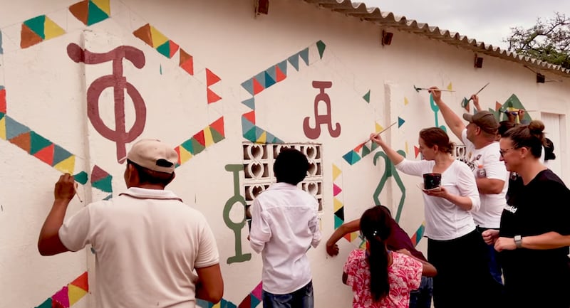WaterAid volunteers together with Wayúu community members paint ancient "Kanaas" symbols on new water infrastructure in La Guajira, Colombia, in a Youtube video published February 3, 2025.