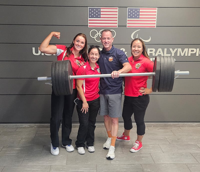 Retired U.S. Marine Maj. Yen Soto, far right, poses for a photo with coaches Brad Johnson and Lydia Figary and with teammate Victoria Rodriguez in the training center at the 2025 Warrior Games in Colorado Springs, Colorado.