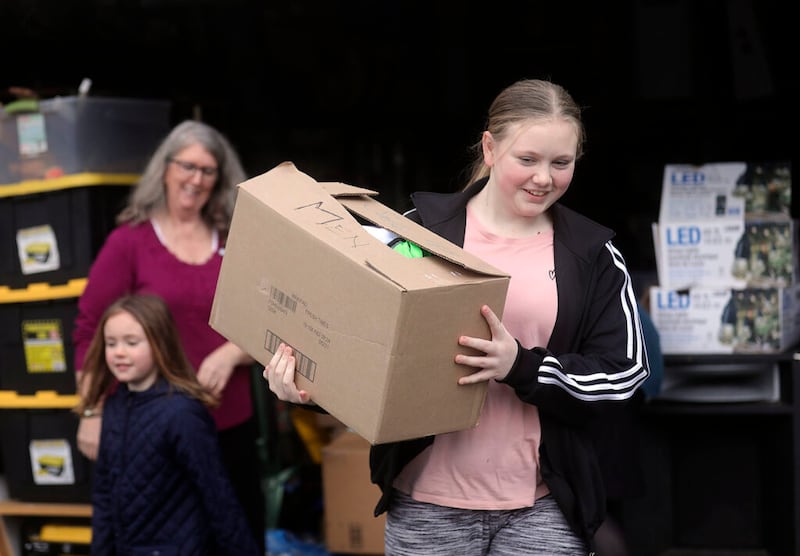 Jordan Wilkie carries a box of hygiene kits from South Hill Stake Relief Society president Mauri Crandall’s garage to her grandmother’s car, to donate to homeless in Puyallup, Wash., on Sunday, Jan. 26, 2020.