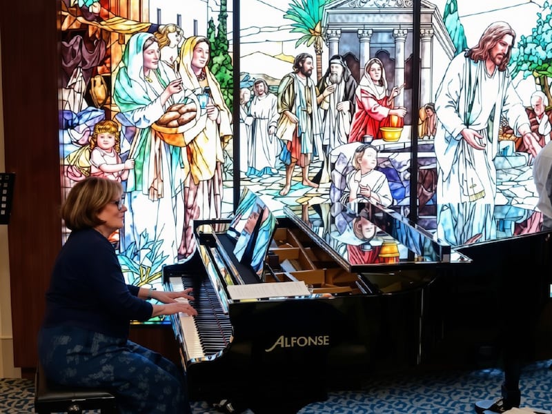 Shawna Edwards — composer of "The Miracle," a new addition to Hymns for Home and Church — plays the piano in the Rome Temple Visitors' Center in Rome, Italy, in April 2026.
