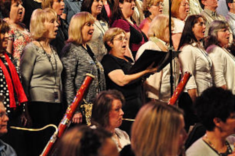 Guest singer Sharyn Schaffter-Margita (holding song book) won a PBS contest to sing with the choir.