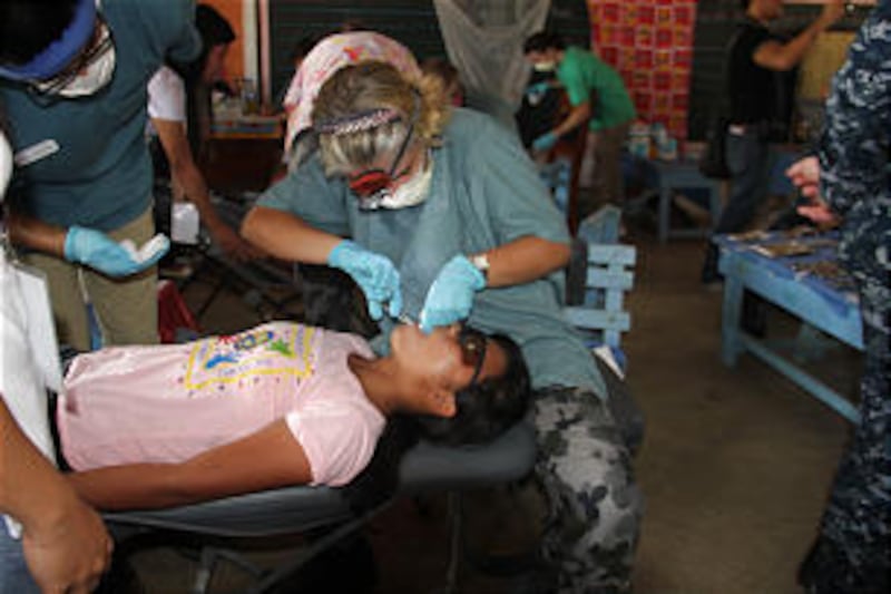 LDS Charities volunteers provide dental and medical services aboard USNS Mercy during ship's visit t