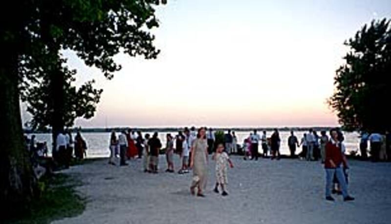 Members linger at waterfront of Mississippi River after walking the Trail of Hope.