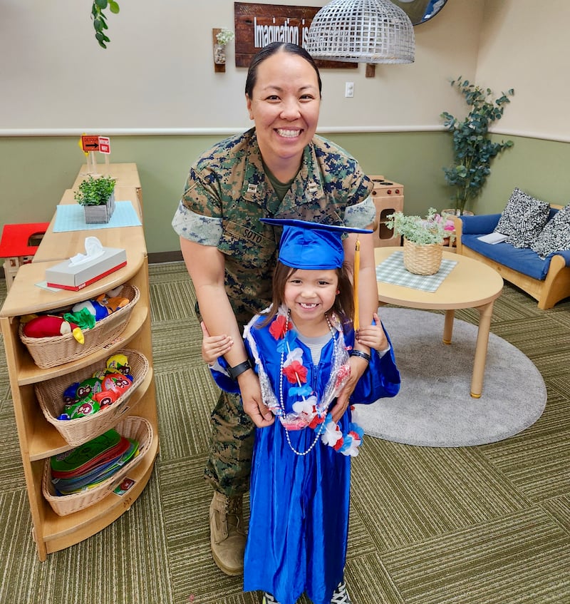 Retired U.S. Marine Maj. Yen Soto poses for a photo with her youngest daughter, Saya Soto, at her daughter's pre-school graduation at Camp Pendleton, northern San Diego County, California, in 2023.