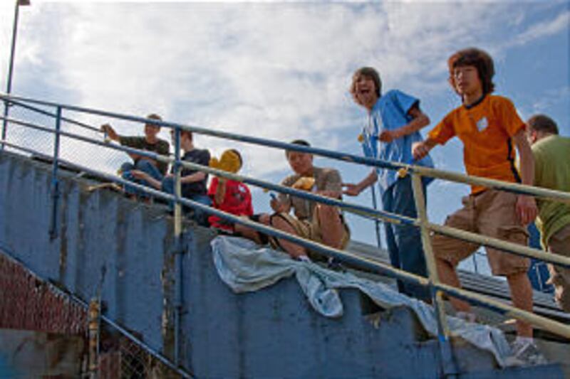 Teens from Portland Oregon Stake paint railings at high school stadium.