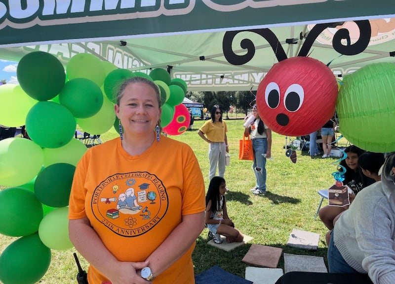 Patience Christenson poses for a picture at one of the booths at the Porterville Celebrates Reading 25th anniversary event in Porterville, California, Saturday, April 11, 2026.
