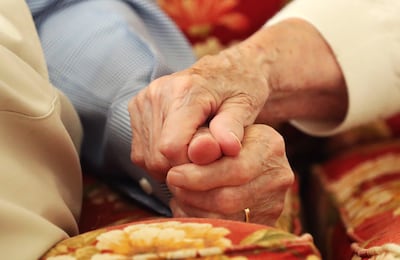 Jim and Colleen Pinegar hold hands as they talk at their home in Orem on Tuesday, Aug. 7, 2018, abou