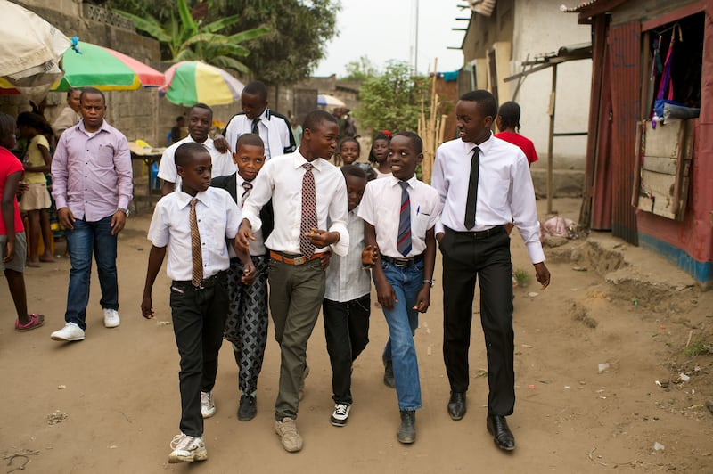 A group of Latter-day Saint young men walk down the street in the Democratic Republic of the Congo in Africa.