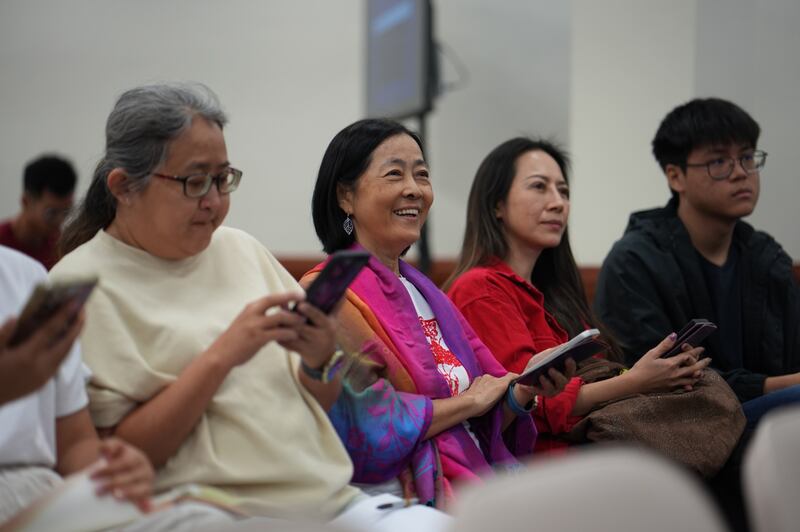Jasmin Choy and her son, right and second from right, participate in learning games during the Asia Area education fair information session in Kuala Lumpur, Malaysia, Oct. 25, 2025.