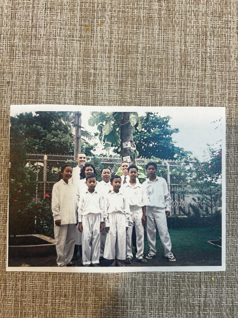 Sam Sophon, Chan Sovan and their five children smile at their baptismal service on June 12, 1999, with Elders Clint Rogers and David Hoare in Phnom Penh, Cambodia.