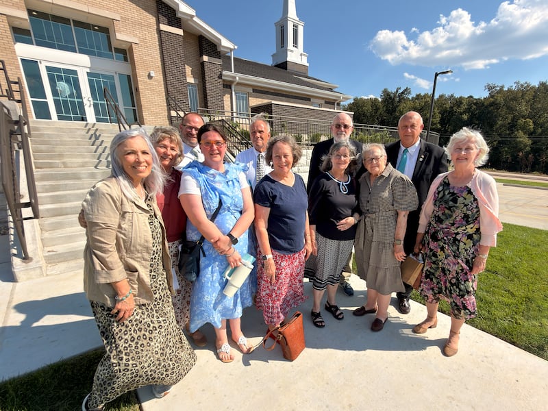 Members of the Cape Girardeau Missouri Stake who had been present when the old stake center was built in 1985 take a picture with the new stake center on Saturday, Sept. 19, 2026.