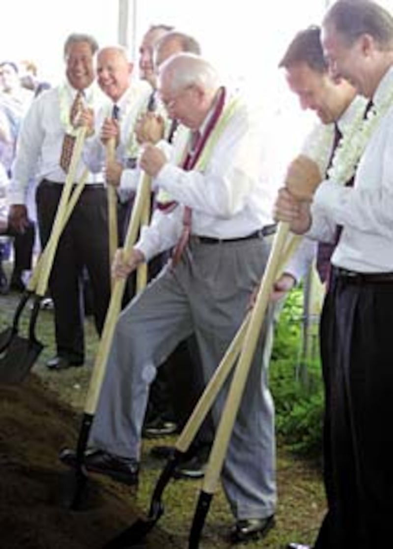 President Hinckley, center, turns shovelful of soil at groundbreaking service.