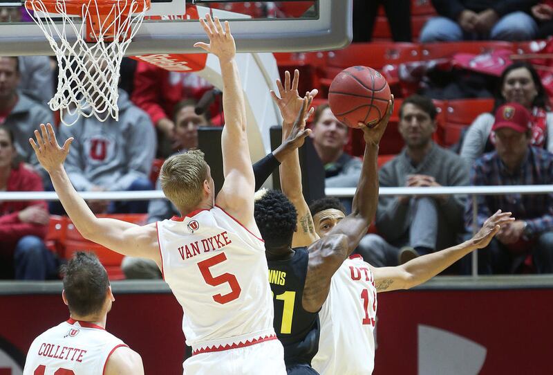 Utah Utes' Parker Van Dyke and Lorenzo Bonam defend Oregon Ducks guard Dylan Ennis in Salt Lake City on Thursday, Jan. 26, 2017.