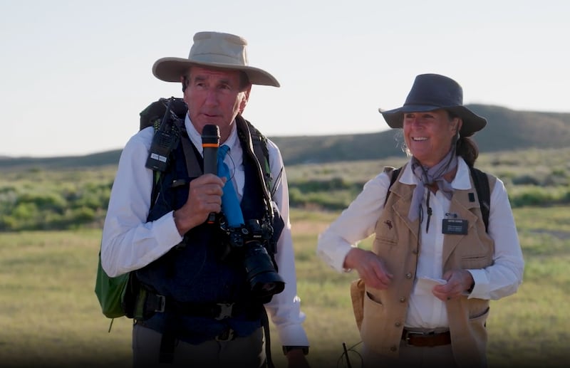 Elder Charles Sypher and Sister Karen Sypher, senior missionaries serving at the Wyoming Mormon Trail Sites, speak to youth in July 2025.
