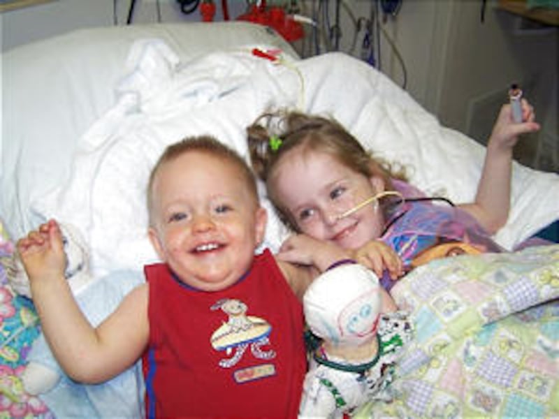 Kendra Herrin plays with her little brother, Austin, who visited Aug. 31. Six days later, Kendra had