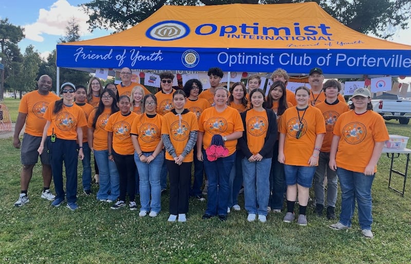 Organizers and volunteers take a picture in front of the Optimist Club of Porterville at the Porterville Celebrates Reading event in Porterville, California, April 11, 2026.