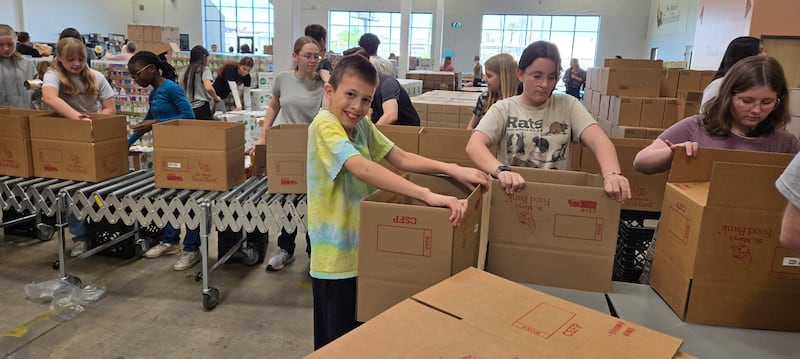 Youth put together boxes of donated food at St. Mary's Food Bank, in Phoenix, Arizona for Global Youth Service Day on Saturday, April 18, 2026.
