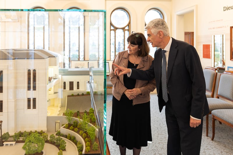 Elder Gérald Caussé of the Quorum of the Twelve Apostles and his wife, Sister Valérie Caussé, look at a model of the Paris France Temple at the Paris France Visitors’ Center in Versailles, France, on Friday, Feb. 27, 2026.