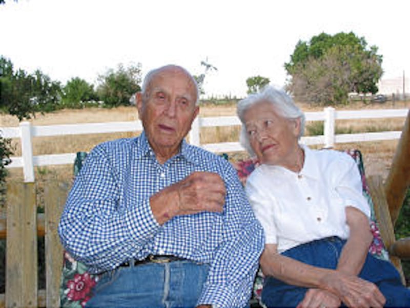 Elder David B. Haight and wife, Ruby, on garden swing in backyard of Oakley, Idaho, home.