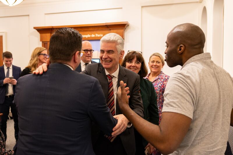Elder Gérald Caussé of the Quorum of the Twelve Apostles and his wife, Valérie, greet new converts at the Paris France Visitors’ Center in Versailles, France, on Friday, Feb. 27, 2026.