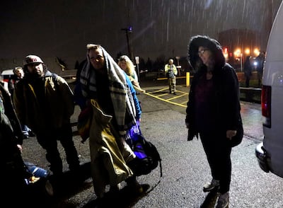 Diane Kienholz, right, picks up homeless people to drive them to Puyallup Nazarene Church so they can sleep for the night in Puyallup, Wash., on Sunday, Jan. 26, 2020.
