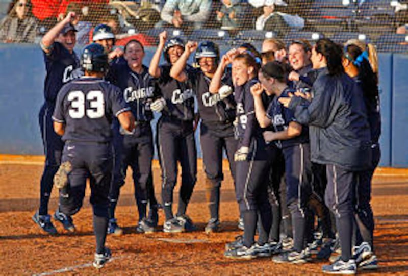 Members of the BYU softball team celebrate Angeline Quiocho's home run during a game last spring. Th