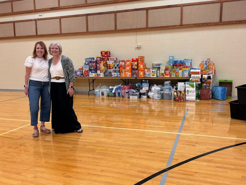 Colorado Springs East Stake Relief Society President Shelli Garrett poses with Pueblo Colorado Stake Relief Society President Mary Marble on July 10, 2026, in front of donations gathered for Aspen Acres fire evacuees.