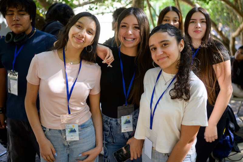 Young women stand together and smile at a For the Strength of Youth conference in Chile on Feb. 10, 2026.