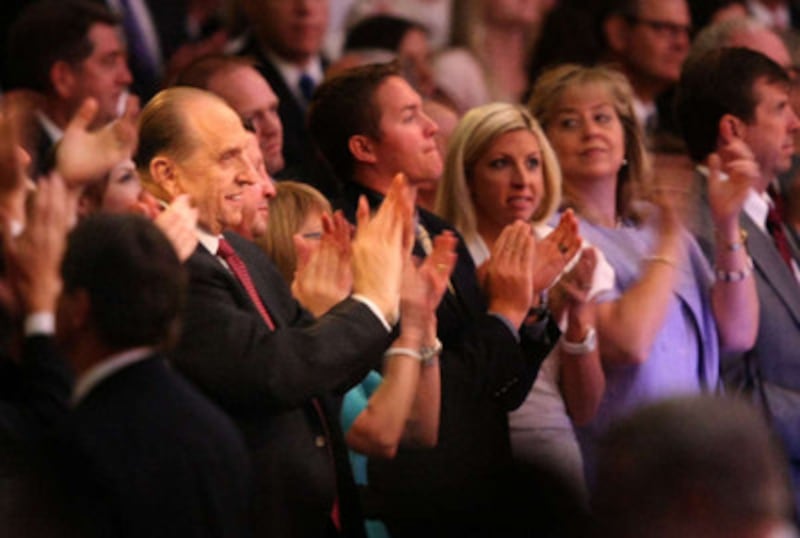 President Thomas S. Monson stands and applauds during a celebration in the Conference Center held to