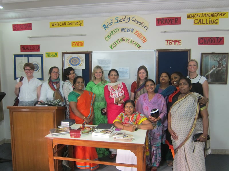 Taunalyn Rutherford, in green, stands with Relief Society sisters during academic research in New Delhi, India, in 2014.