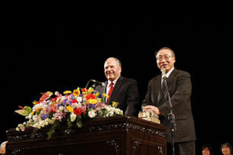 Elder Ronald Rasband, left, of the Presidency of the Seventy speaks with aid of interpreter, Hiroshi