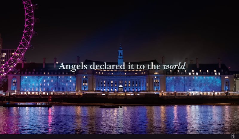 A scene from the 2024 Light the World video, "A Worldwide Celebration of Jesus Christ's Birth," shows Nativity images projected onto County Hall by the Thames River in London, with the words, "Angels declared it to the world."