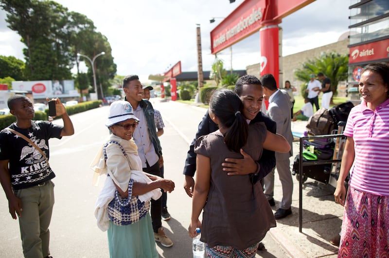 A returning missionary greets friends and family outside the airport in Madagascar in 2026.