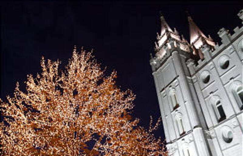 Visitors gets their first look at the lights on Temple Square after they were turned on as part of a
