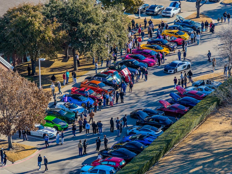 Dozens of cars are seen in a drone shot parked outside a meetinghouse in Plano, Texas, for a "Cars and Christ" event on Saturday morning, Feb. 7, 2026.